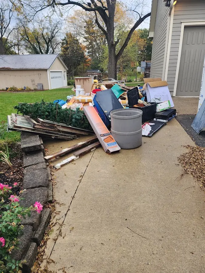 Dumpster being loaded with debris for 3 Yard Dumpster Rental in Millcreek